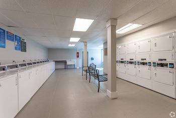 a large room with a row of mailboxes and benches